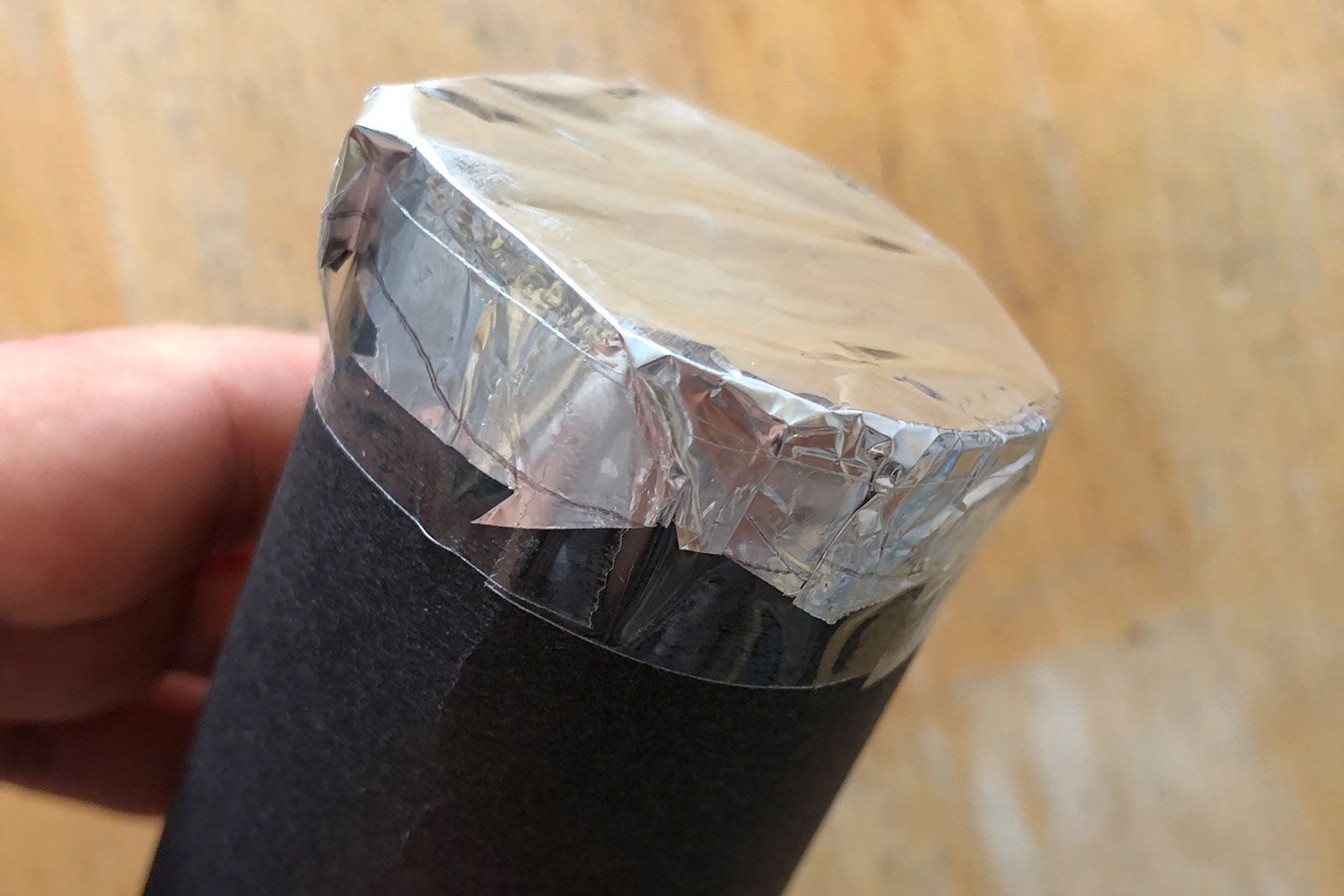 Das Ende der gebastelten Lochkamera wird mit Alufolie verklebt.